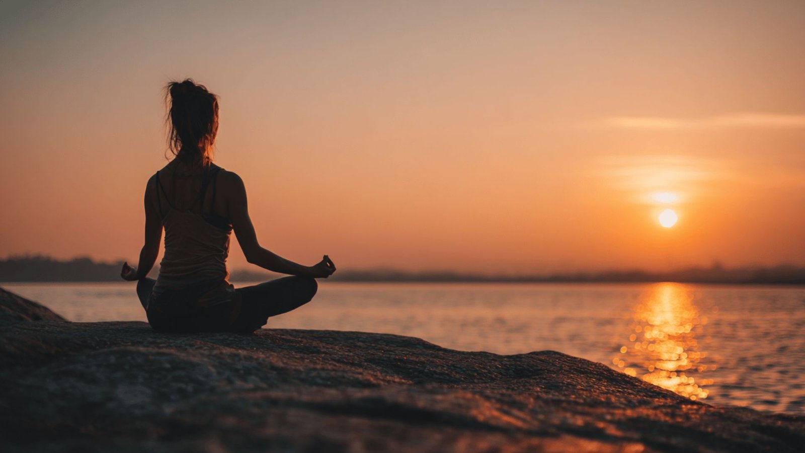 A person practicing one of several simple healthy lifestyle habits, such as meditating in the morning.